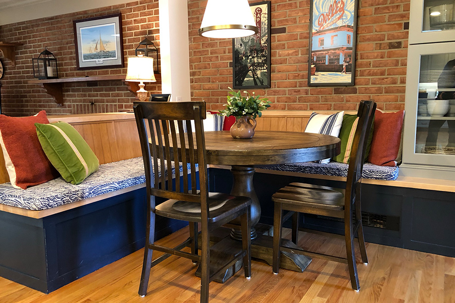 Renovated kitchen in Columbia Maryland featuring brick wall and table