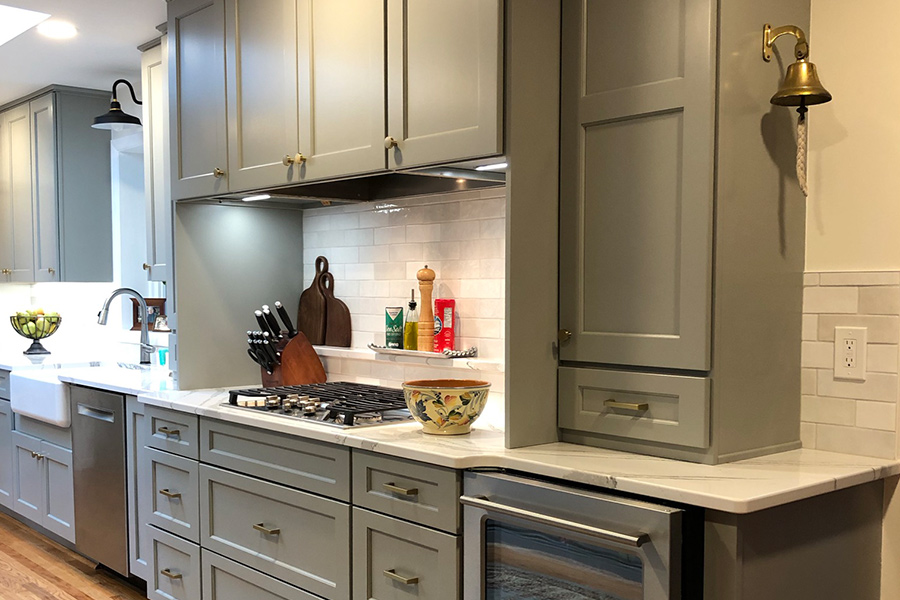 Modern kitchen with gray cabinets and white countertops in Columbia, MD