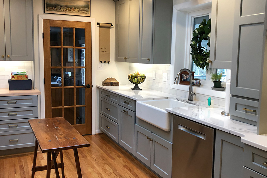 Stylish Columbia, MD kitchen with gray cabinets and white counters.