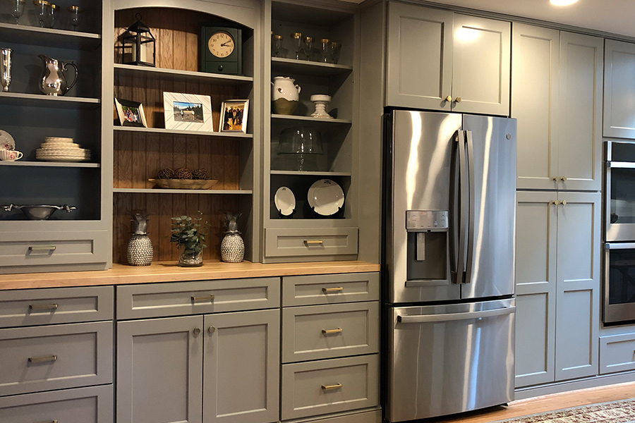 Modern kitchen with gray cabinets and stainless steel appliances in Columbia, MD